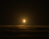 A rocket with the InSight lander punches through the clouds.