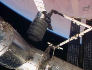 Orbital Sciences' Cygnus cargo spacecraft is moved into installation position by astronauts using a robotic arm aboard the International Space Station. --NASA image.